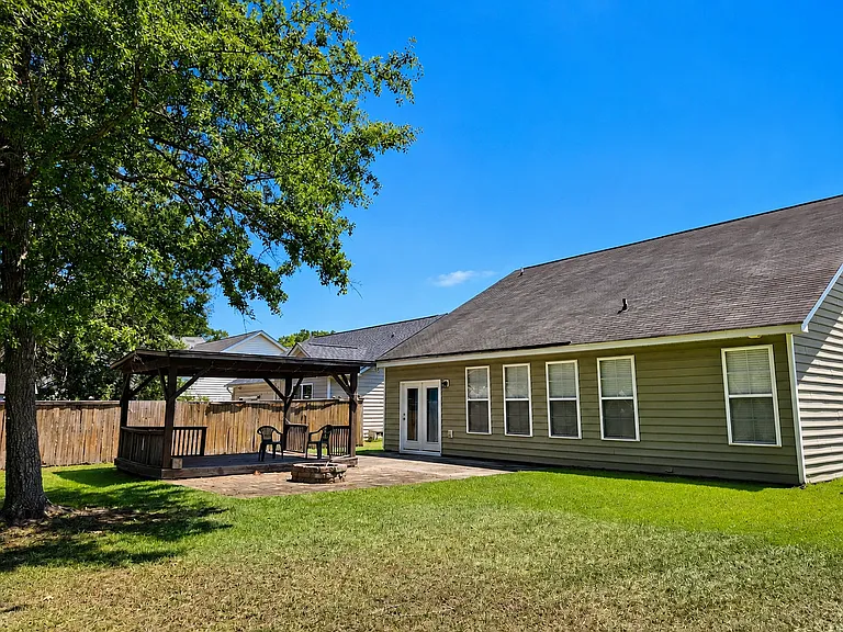 15' x 12' covered patio with a 10' x 10' fire pit area adjacent to it to enjoy the pond views.