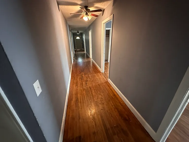Each door to the right is a bedroom, door at the end takes you out to the front yard