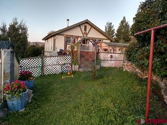 Summer grassy lawns, green house included, multilevel deck off the back door, partial fence.