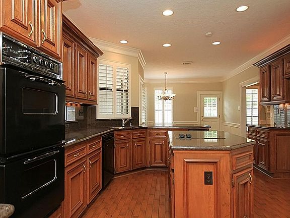 Large kitchen with island and many cabinets.