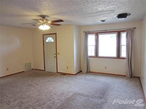Living Room.  Newer Carpet throughout.  New Hi-Efficiency Windows