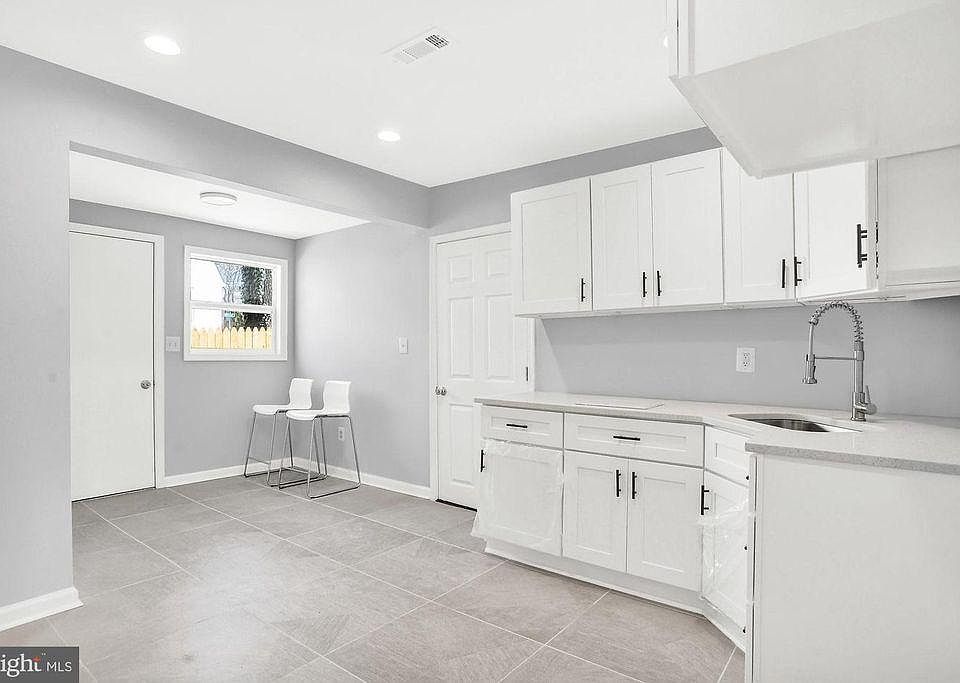 Open kitchen and living room. Would look adorable with breakfast nook or dining table.