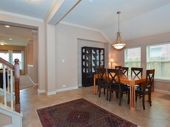 Grand formal dining room that will fit a 8-10 person table with crown molding.