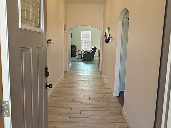The residence features a long, inviting walkway leading to the front entry.