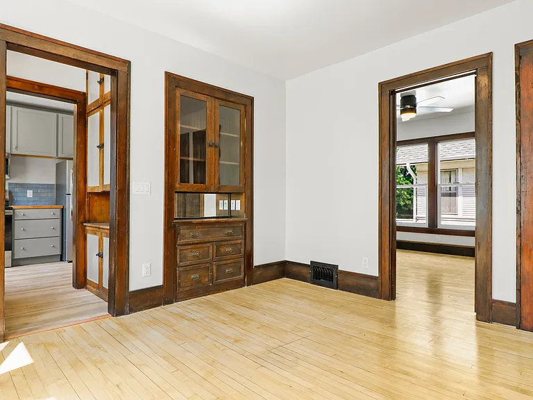 Top unit, original butler pantry and built in shelves. Door to the right leads to a wide and generous stairwell. Door in the middle leads to first bedroom.