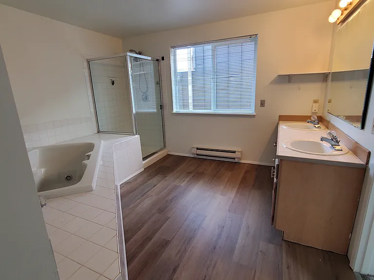 Bedroom 1: primary bedroom suite has a soaker tub and walk-in shower.