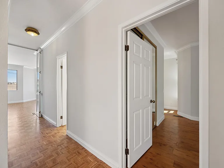 Upper hallway leads to the primary suite and the powder room.