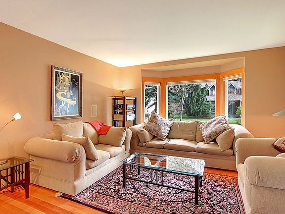 Sunken living room, eucalyptus floors, bay windows. 