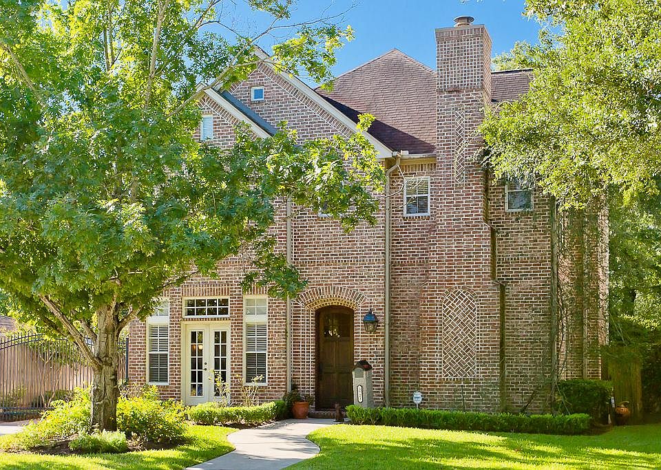 Classic Spaulding Tudor Style home replicating an antique brick exterior with herringbone inlays. In