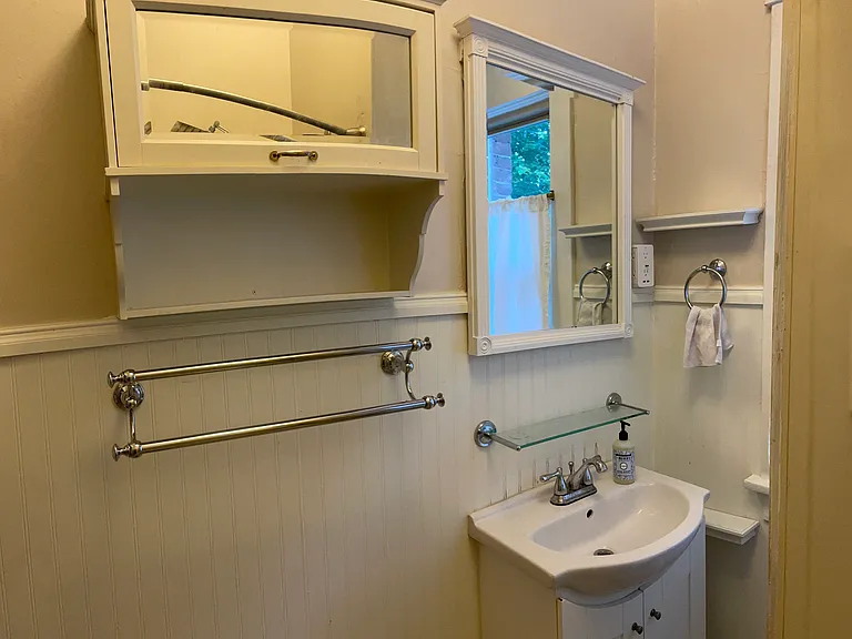 Double towel racks and cabinet. There is a full size linen closet just outside the bathroom in the hallway for plenty of storage.