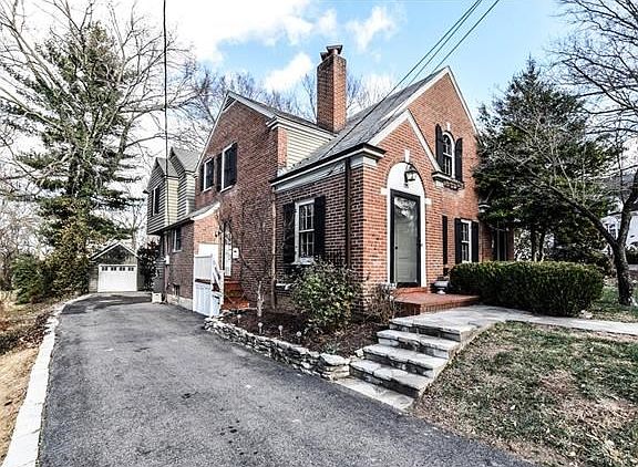 Long drive to detached garage. Garage has new door, new paint.