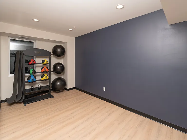 Open floor space with equipment for flexible workouts.