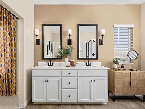 Primary bath with vanity and tile flooring