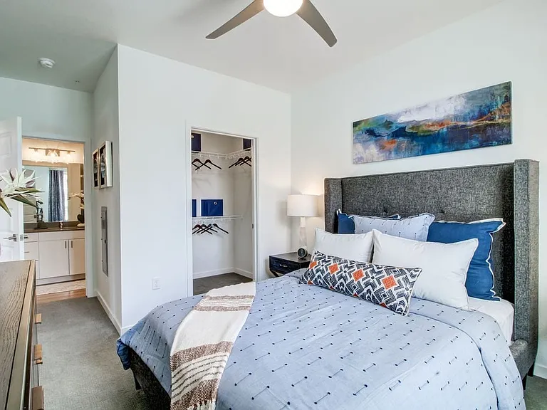 Bedroom with ceiling fan and carpeted flooring
