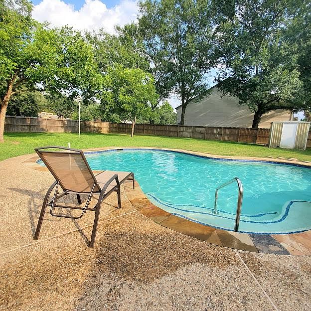 View of pool in backyard