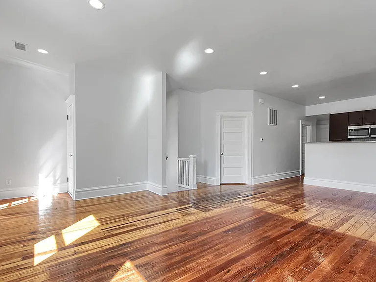 Family Room - salvaged hardwood floors, venetian blinds, coat closet
