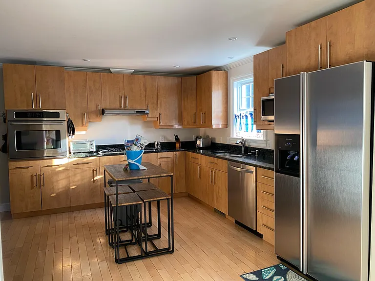 Convenient island with seating for 4. Gas cooktop with 6 burners. Fridge with ice maker and filtered water.