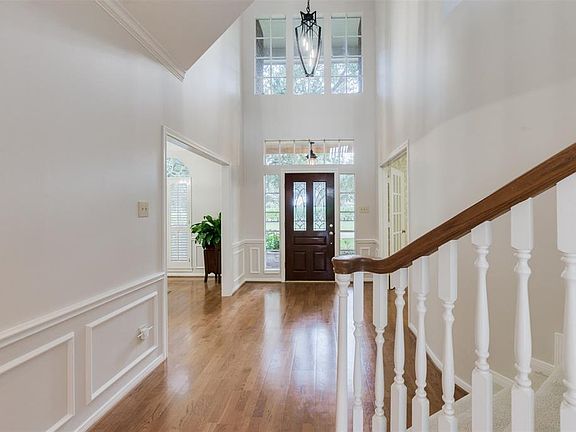 The brilliant Two Story Foyer with new designer Chandelier and Tall Window above the door set the magnetic tone for the home from the moment you enter. The natural light welcomes you and the light paint color scheme brings a ageless charm along with 