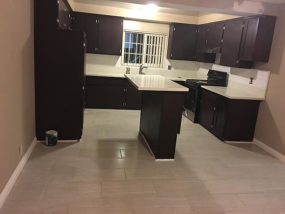 New floor, new white quartz countertops, new stove.