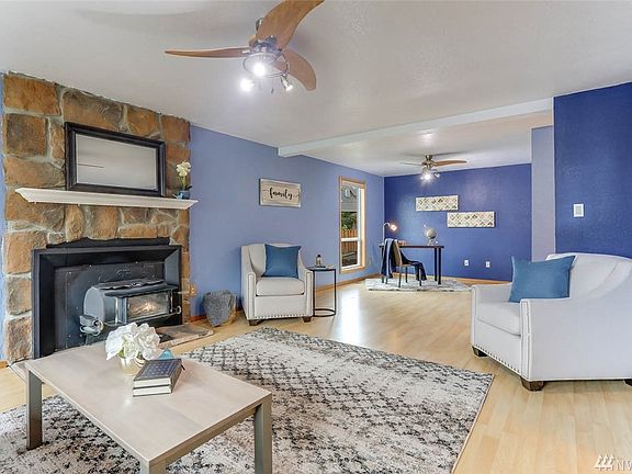 The floor to ceiling stone fireplace adds charm while the wood-burning stove makes chilly nights cozy.