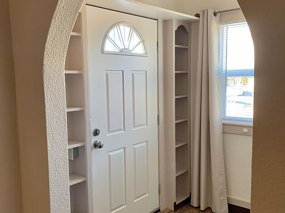 Entry with window, built in shelves, and coat closet (not pictured)