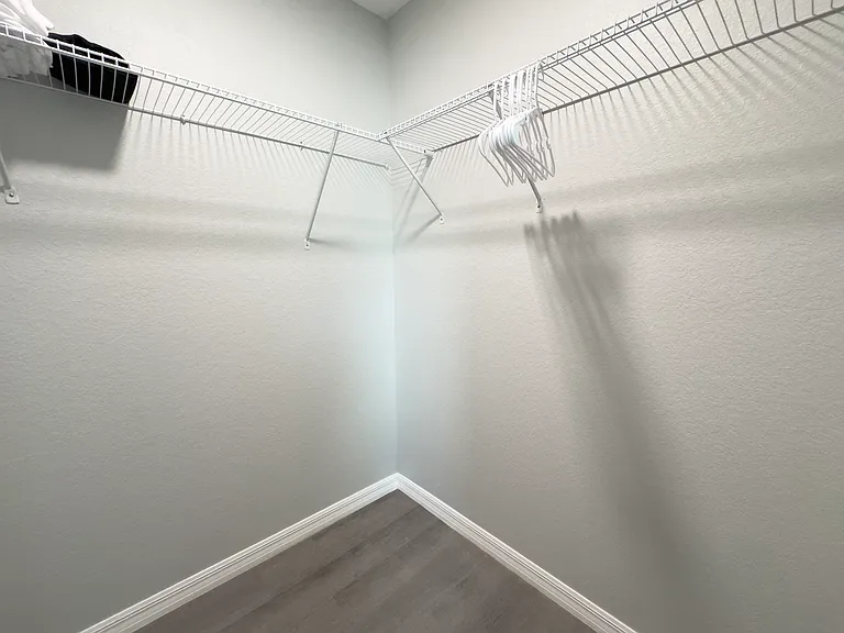 Master bedroom walk-in closet with generous shelving and hanging space.