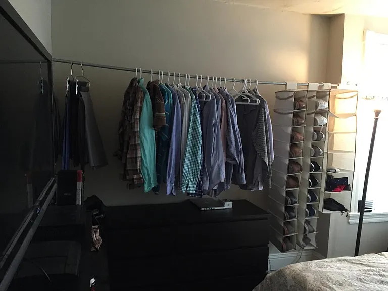 Exposed closet in rear bedroom.