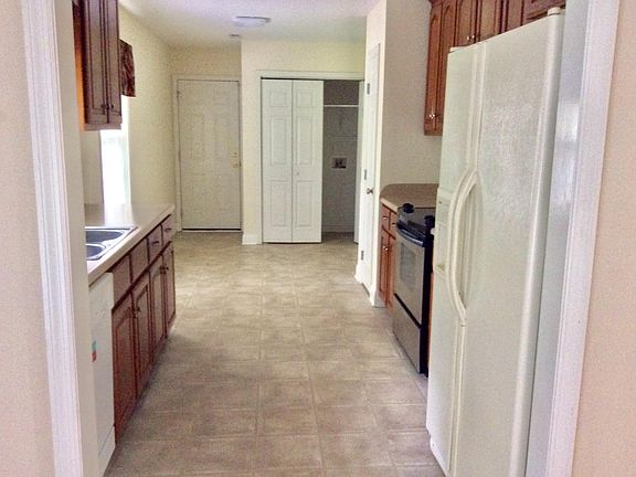 Washer/dryer hook-up behind bi-fold doors in kitchen.