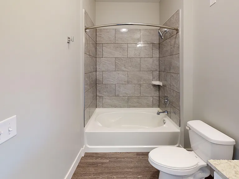 The main bathroom in The Dogwood floor plan includes a luxurious showerhead and large bathtub. The main bathroom in The Dogwood floor plan includes a luxurious showerhead and large bathtub.