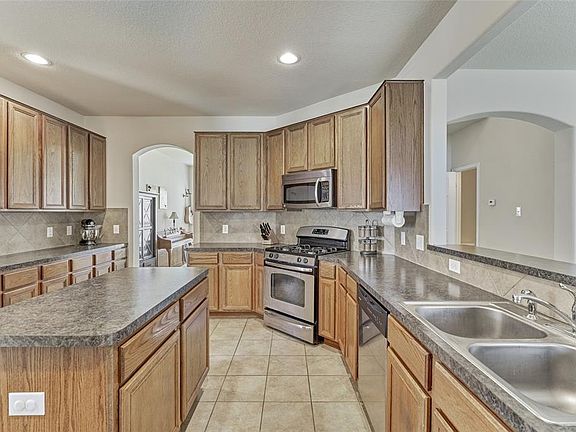 The fantastic Island kitchen features a gas cooktop, stainless steel appliances, a large breakfast bar and lots of counter space!