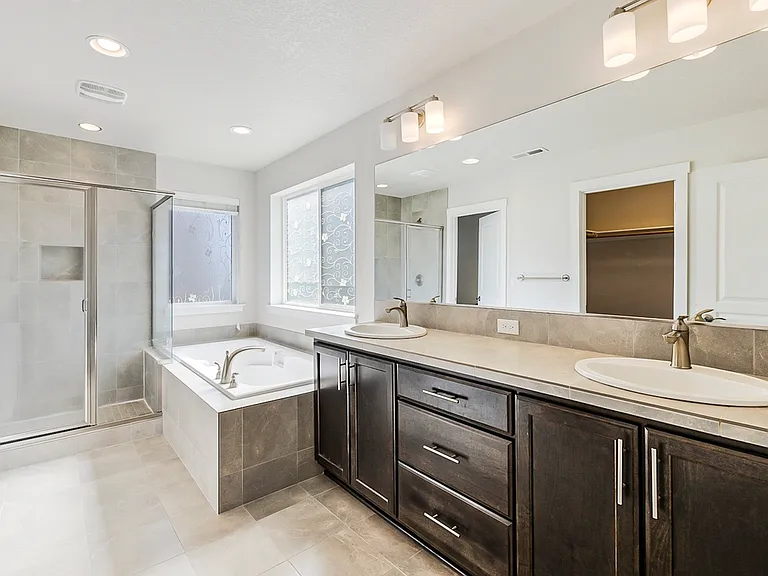 Master bathroom with a large tub and stand in shower