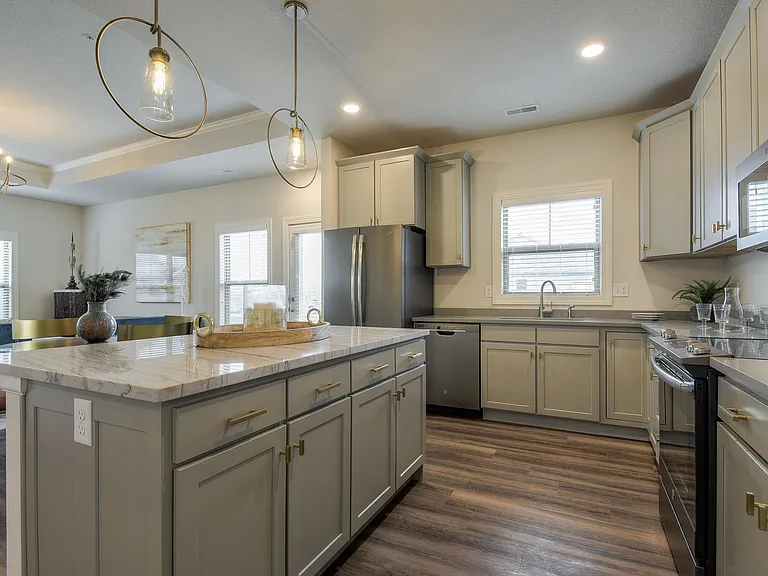 The Torrance- Spacious Kitchen w/Large Center Island Located in the Center of the Villa with Bedrooms at the Back of the Villa