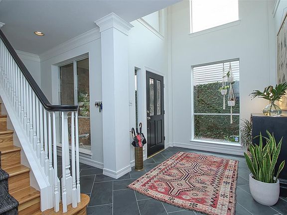 The foyer is double height with light from many large picture windows.
