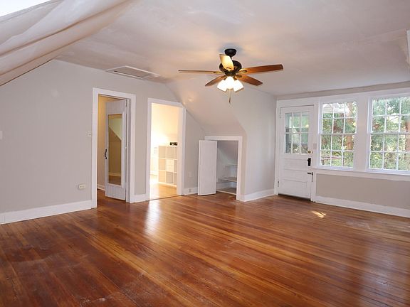 Expansive living room connects to bedroom and kitchen. Lots of natural light through windows. This room also has ceiling fan with light fixture.