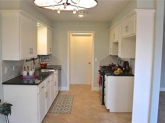 Kitchen and laundry room with entrance to garage.