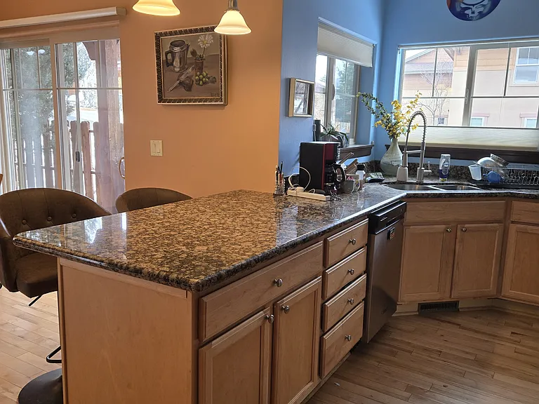 Countertop with leather, adjustable and swivel stools.
