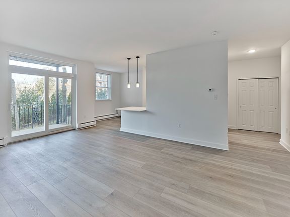 Open living and dining area with natural light and balcony access at Crestwood Apartments in Wayne, PA