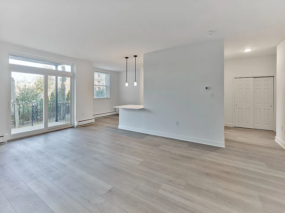 Open living and dining area with natural light and balcony access at Crestwood Apartments in Wayne, PA