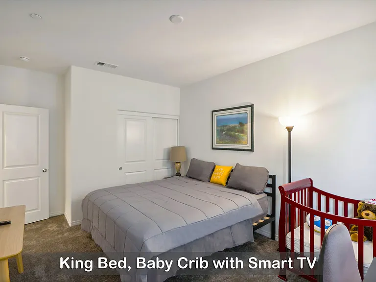 King bed with a baby crib, perfect for families traveling with little ones.