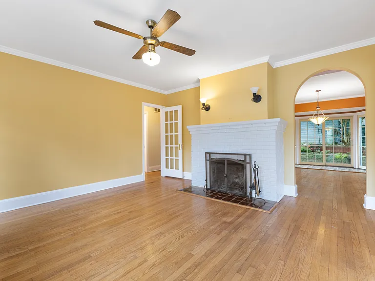 Another view of the expansive living room highlighting the gorgeous hardwood flooring.