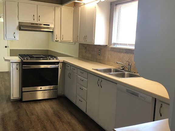 New 5-burner gas range and new stainless vent hood. New Dishwasher. Great view standing at kitchen sink. Lots of cabinet and counter space.