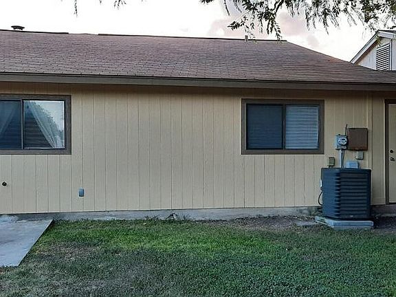 Rear of house with storage area on right.