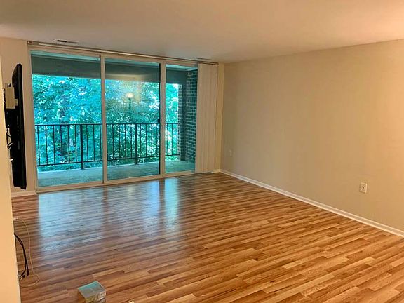 The living room features a big sliding door exiting to a nice covered balcony/patio