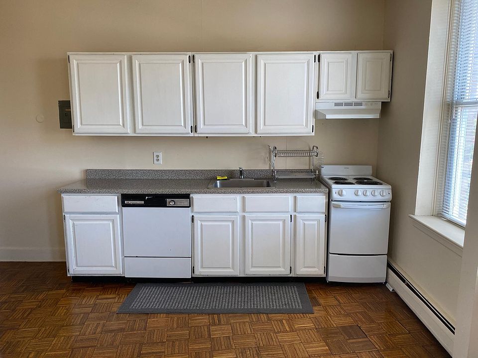 Open concept kitchen with new countertops and dishrack