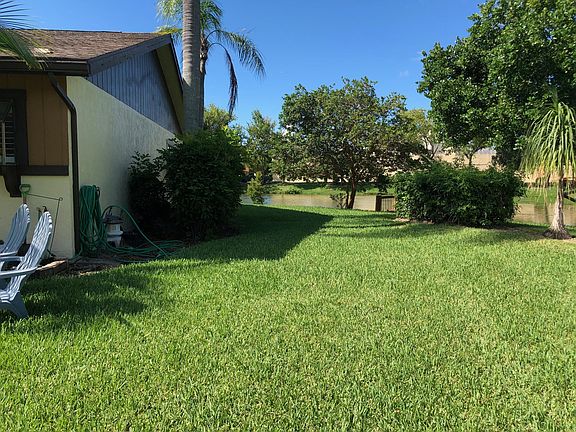 Expansive Side and back yard with lake access and private do