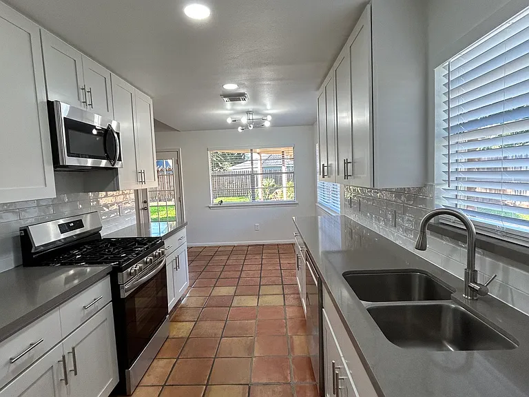 Spacious gallery kitchen with a lot of cabinets