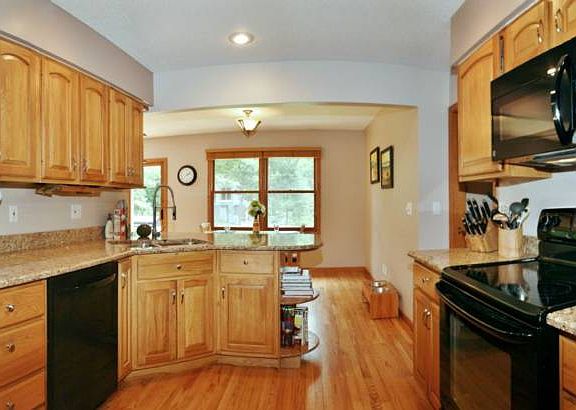 The kitchen has hardwood floors and is in the center of the home.  It looks out over the sun room and the wall of windows and sliding doors. All new kitchen appliances stay with the home. There is plenty of cabinet and counter space for any cook. Another wall of cabinets and more counter space is on the opposite end of the room. Beautiful granite counter tops in the kitchen were just installed and extended to create a...