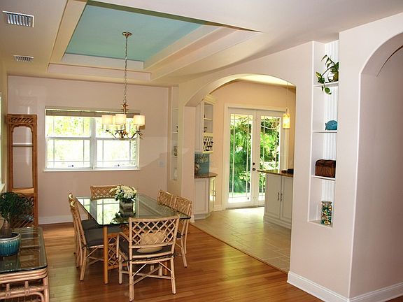 Dining Room : Tray ceiling, built-in shelving, and arches give the home a custom feel.