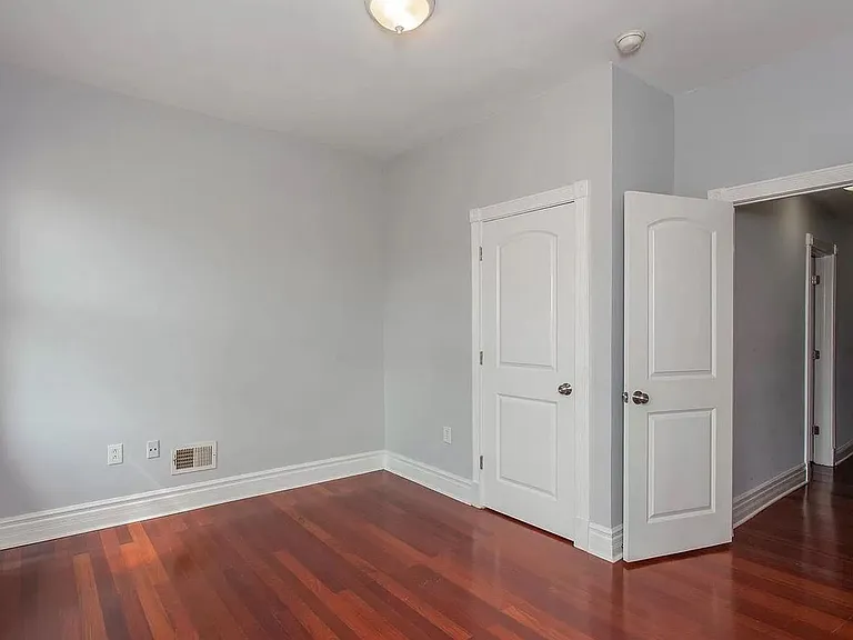 Unfurnished Front Bedroom with previous light fixture. Currently there is a ceiling fan with light