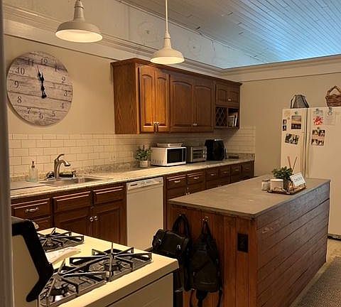 Spacious kitchen with tons of cabinets and an island and a eating nook